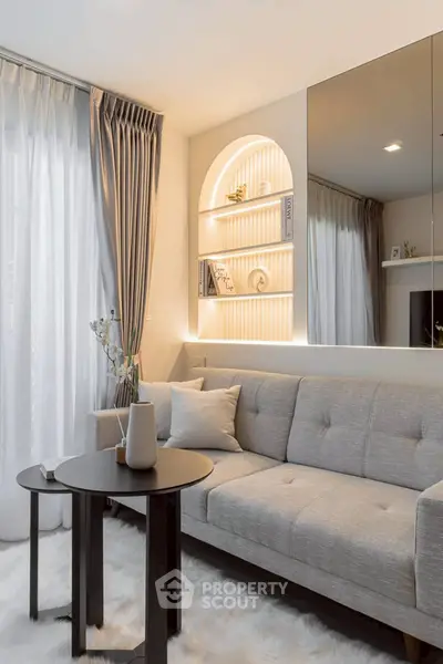 Modern living room with elegant decor, plush sofa, and ambient lighting for a cozy atmosphere.
