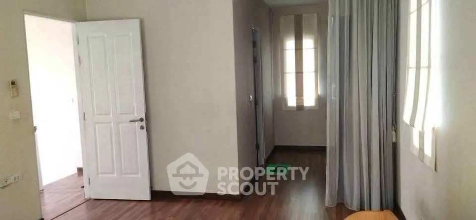 Spacious interior with wooden flooring and natural light, ideal for modern living.