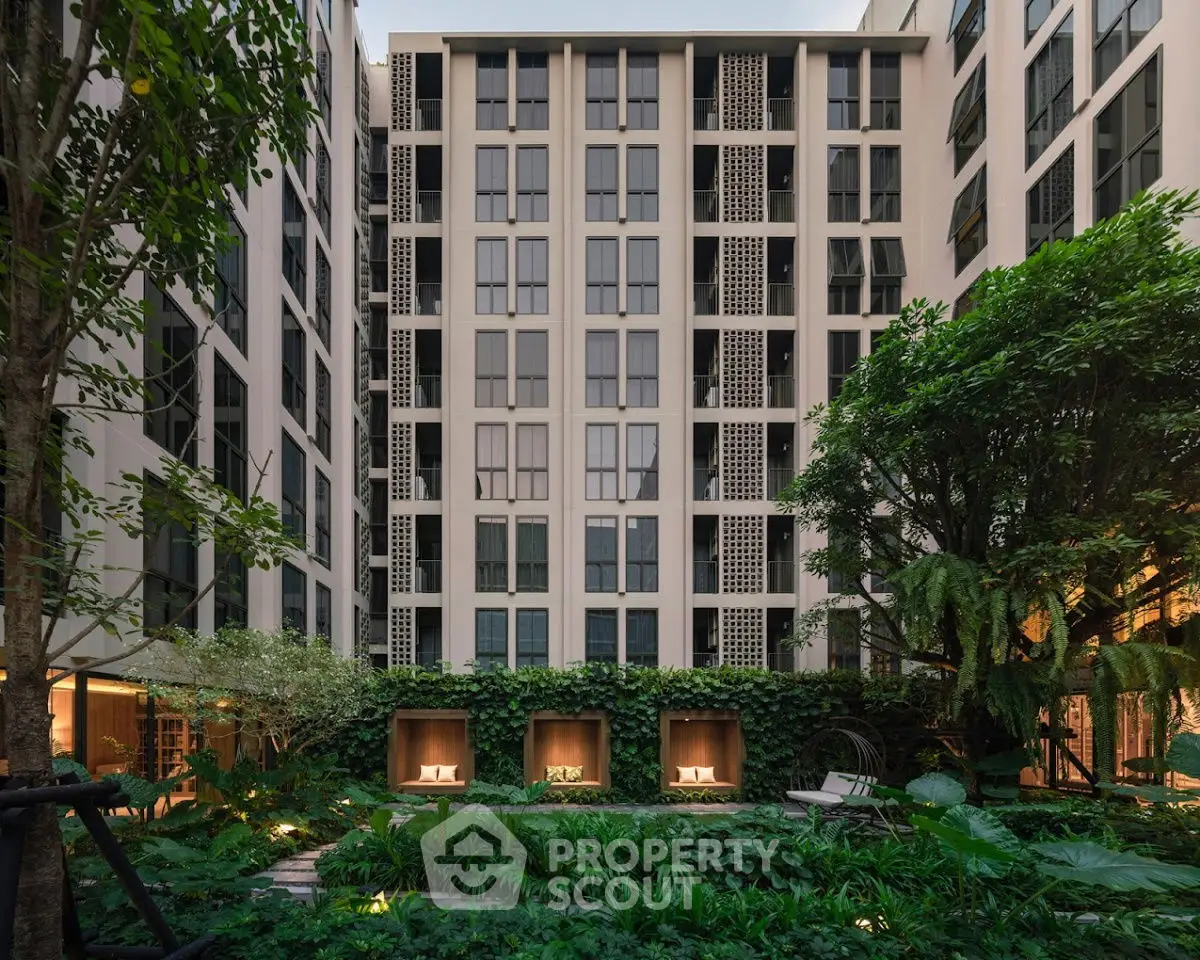 Luxurious modern apartment building with lush garden view