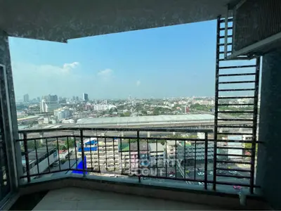 Stunning cityscape view from high-rise balcony with modern railing design.