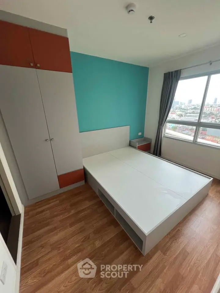Modern bedroom with built-in wardrobe and city view window