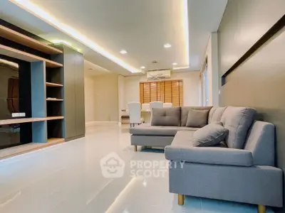 Spacious modern living room with sleek design and comfortable seating.