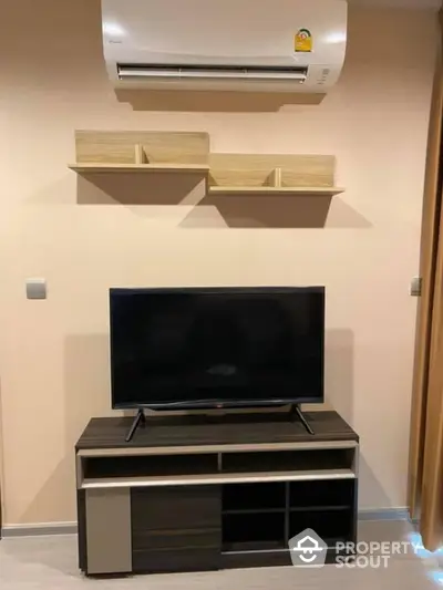 Modern living room with sleek TV stand and wall-mounted air conditioner