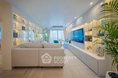 Luxurious modern living room with elegant built-in shelving and large flat-screen TV, perfect for stylish entertaining.