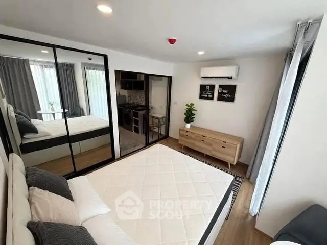 Modern bedroom with mirrored closet and air conditioning in stylish apartment