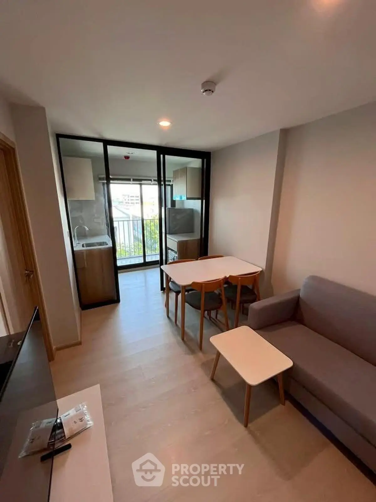 Modern living room with open layout and balcony view in stylish apartment