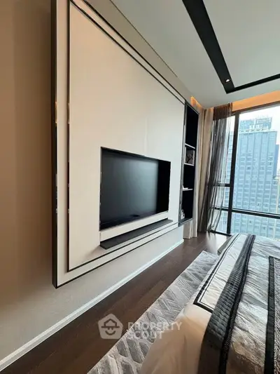 Luxurious bedroom with modern TV setup and stunning city view