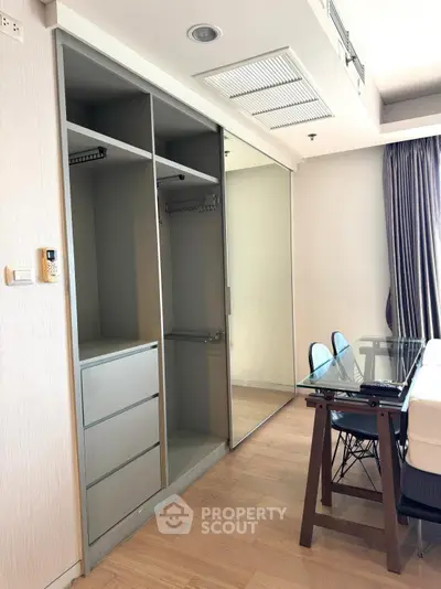 Modern apartment interior with built-in wardrobe and dining area