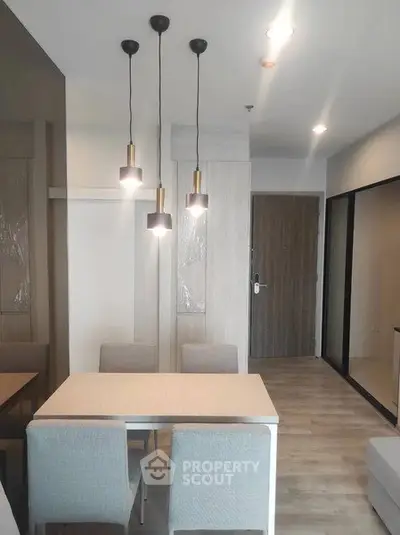 Modern dining area with stylish pendant lights and sleek furniture