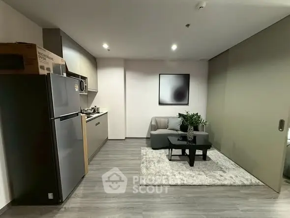 Modern studio apartment with sleek kitchen and cozy living area, perfect for urban living.
