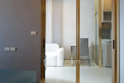 Modern interior with sliding glass doors, white sofa, and sleek dining area.