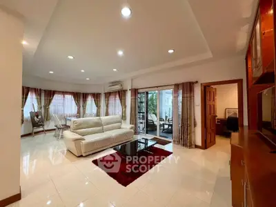Spacious living room with elegant decor and large windows for natural light.