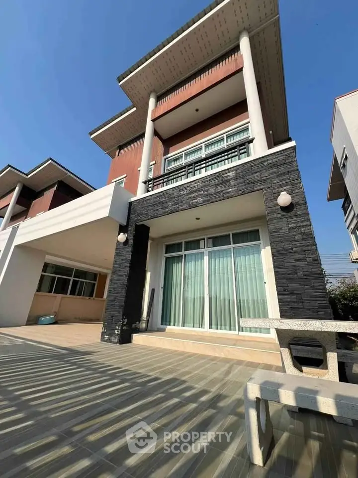 Modern multi-story house with spacious patio and elegant facade