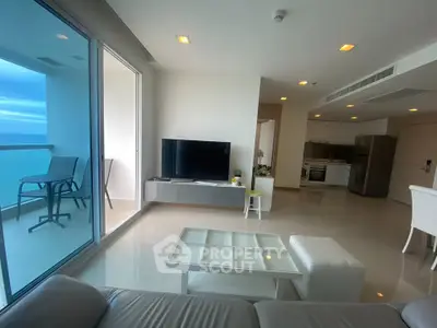 Spacious modern living room with ocean view balcony and sleek kitchen
