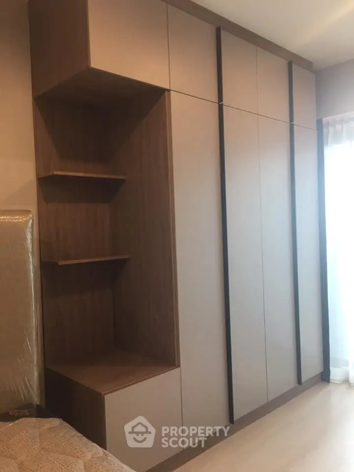 Modern bedroom with sleek built-in wardrobe and natural light