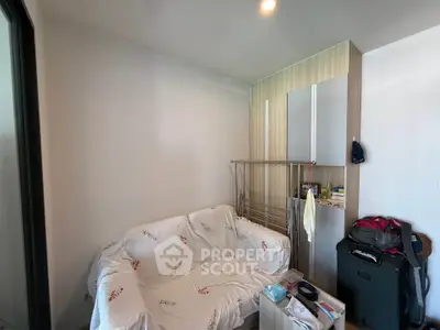 Cozy small living room with sofa and storage space, ideal for compact urban living.