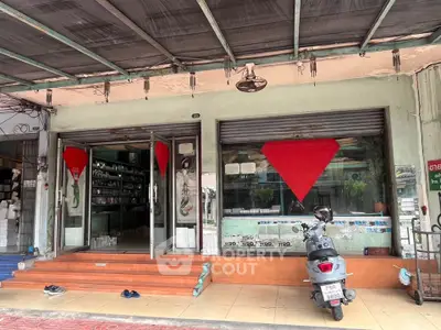 Charming commercial storefront with large glass windows and inviting entrance, perfect for retail or office space.