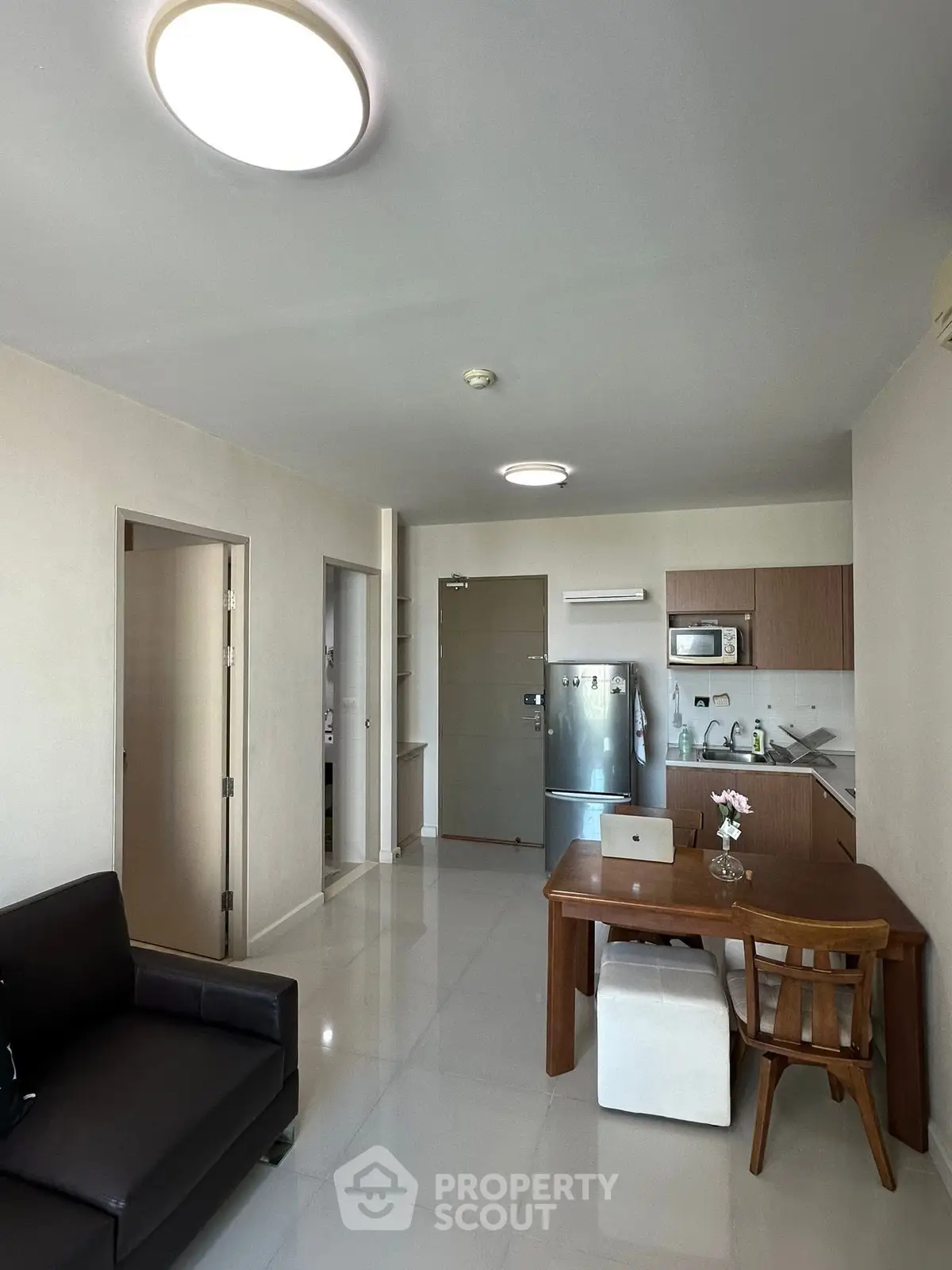 Modern open-plan kitchen and living area with sleek furniture and appliances.