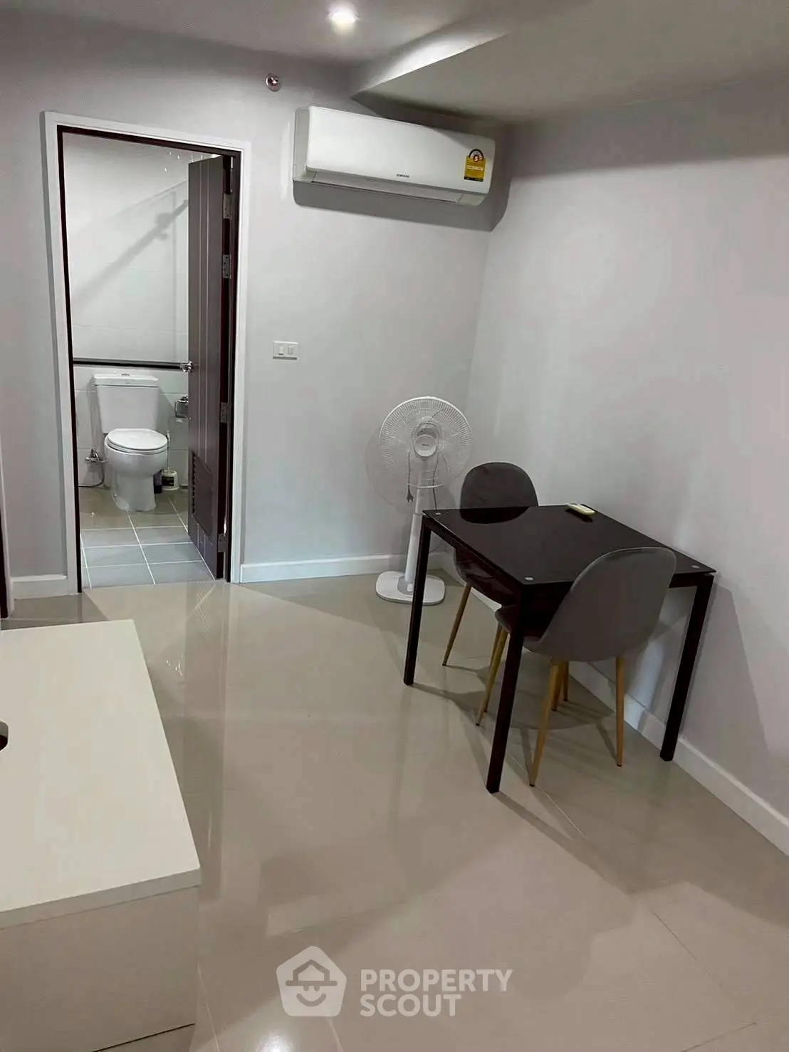Modern compact living space with dining area and view into bathroom