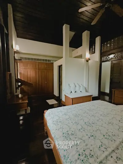 Charming bedroom with wooden accents and cozy decor in a serene setting.