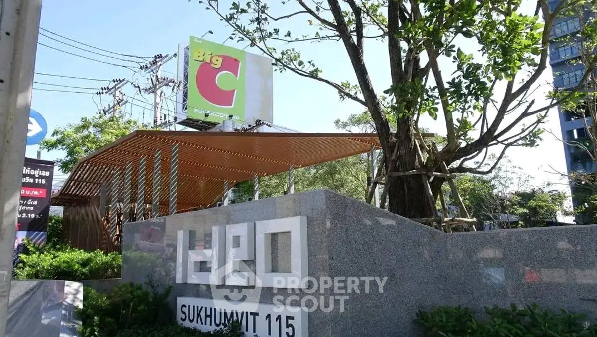 Modern condominium entrance with lush greenery at Ideo Sukhumvit 115