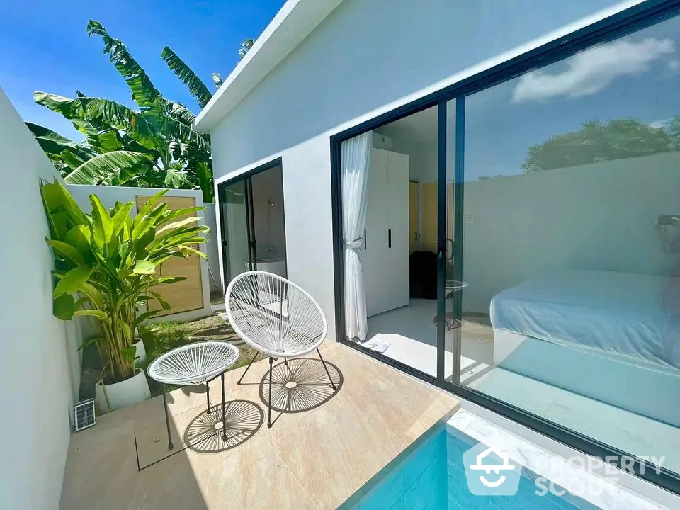 Modern villa with private pool and stylish patio furniture, perfect for relaxation and luxury living.