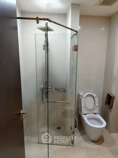Modern bathroom with glass shower and sleek toilet design