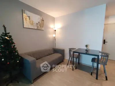 Cozy living room with modern decor and Christmas tree, perfect for festive gatherings.