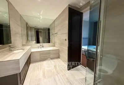 Luxurious modern bathroom with sleek design and bathtub in upscale property