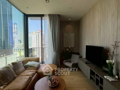 Modern living room with city view, stylish furniture, and floor-to-ceiling windows.