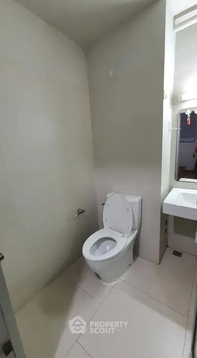 Modern bathroom with sleek white tiles and compact design