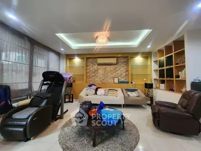 Spacious living room with modern decor and cozy seating area, perfect for relaxation and entertainment.