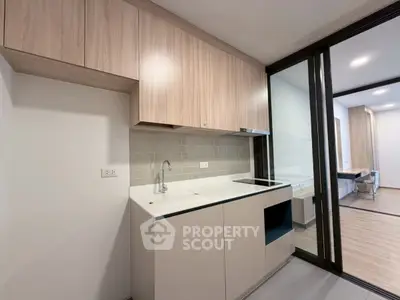 Modern kitchen with sleek cabinetry and open layout in contemporary apartment