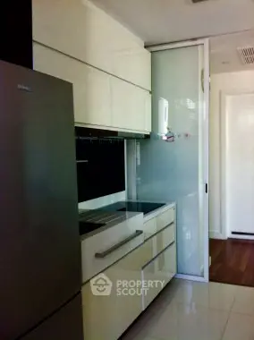 Modern kitchen with sleek cabinetry and stainless steel fridge