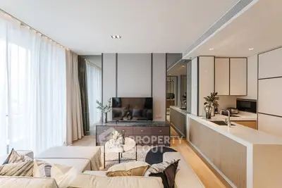 Modern living room with open kitchen, stylish decor, and natural light