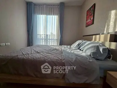 Cozy bedroom with natural light and modern decor, perfect for relaxation and comfort.