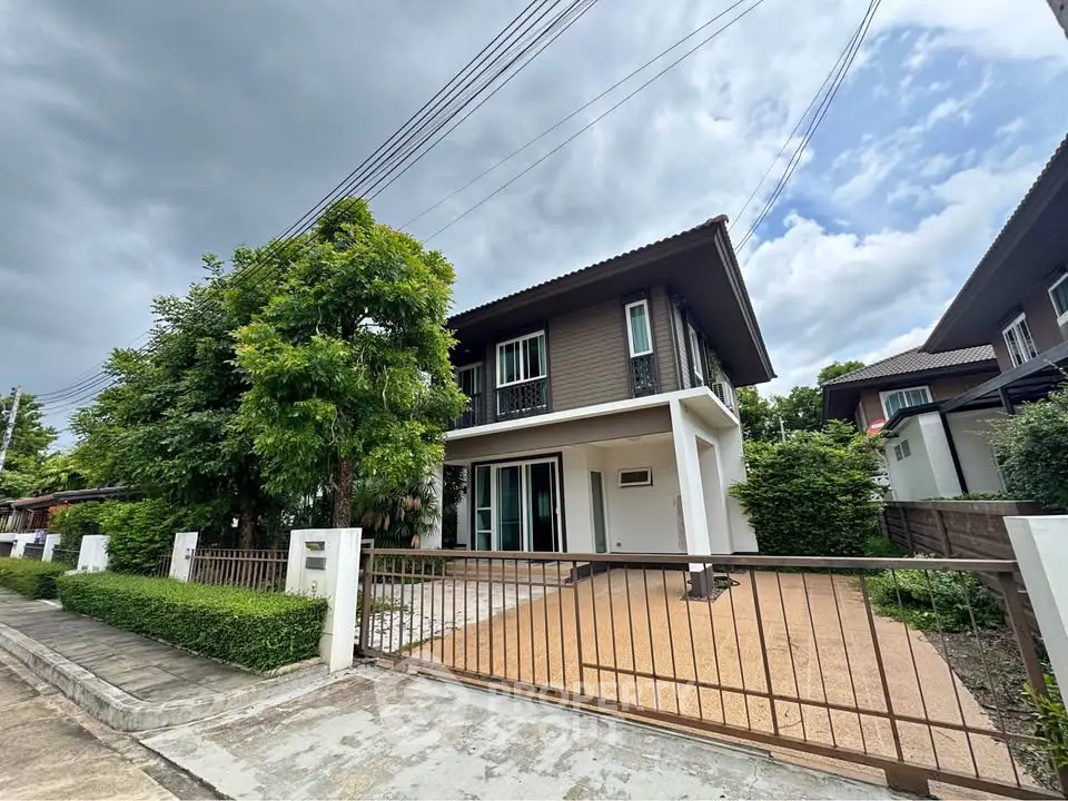Charming two-story house with lush greenery and spacious driveway in a serene neighborhood.
