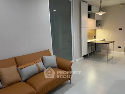 Modern living room with stylish sofa and compact study area, perfect for urban living.