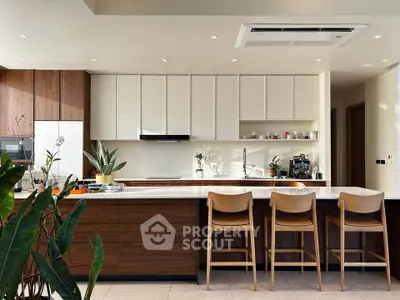 Modern kitchen with sleek cabinetry and island seating in a contemporary home.