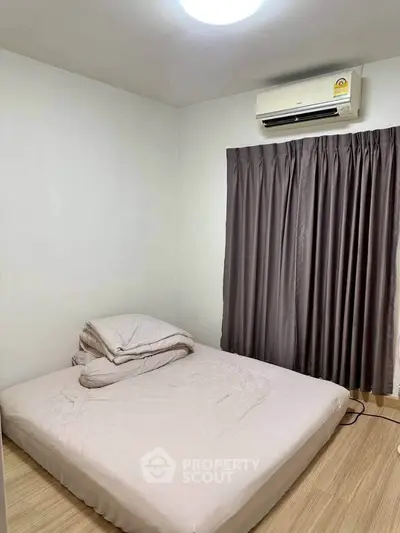 Cozy bedroom with air conditioning and minimalist decor, perfect for restful nights.