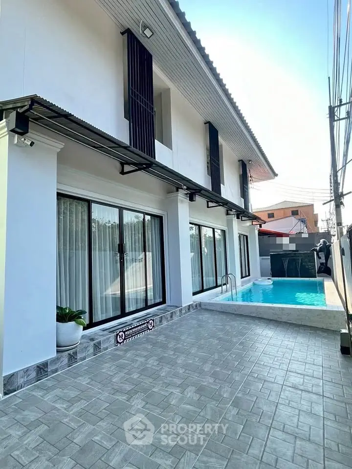 Modern two-story home with private pool and spacious patio area.