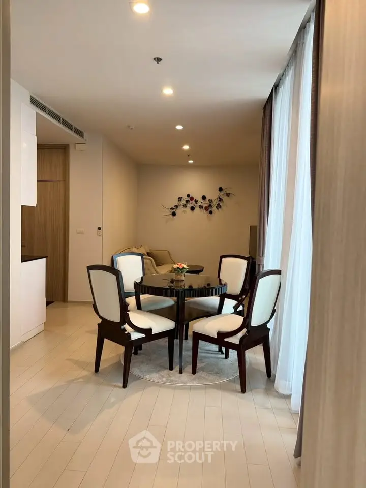 Elegant dining area with stylish chairs and modern decor in a cozy apartment setting.