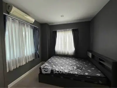 Modern bedroom with dark walls and large windows, featuring a sleek air conditioning unit.