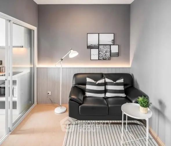 Modern living room with sleek black sofa and stylish decor