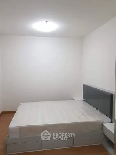 Minimalist bedroom with modern bed frame and soft lighting