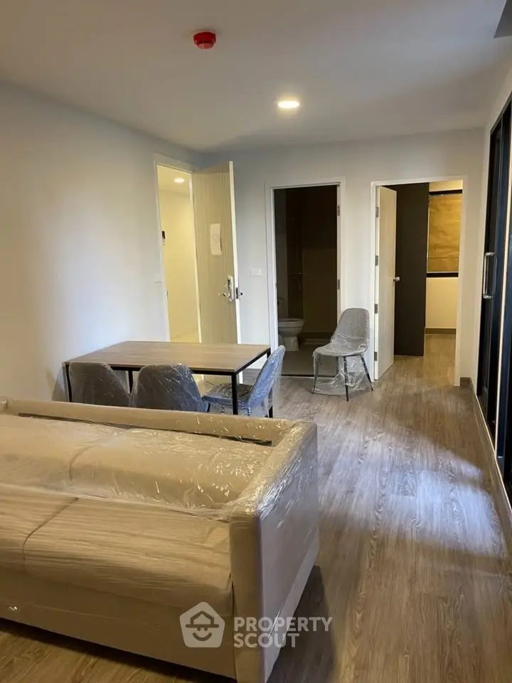 Modern living room with dining area and open kitchen in a stylish apartment.