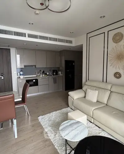 Modern open-layout living room with sleek kitchen and stylish decor