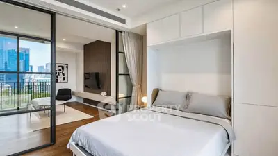 Modern bedroom with sliding glass doors leading to a stylish living area and city view.