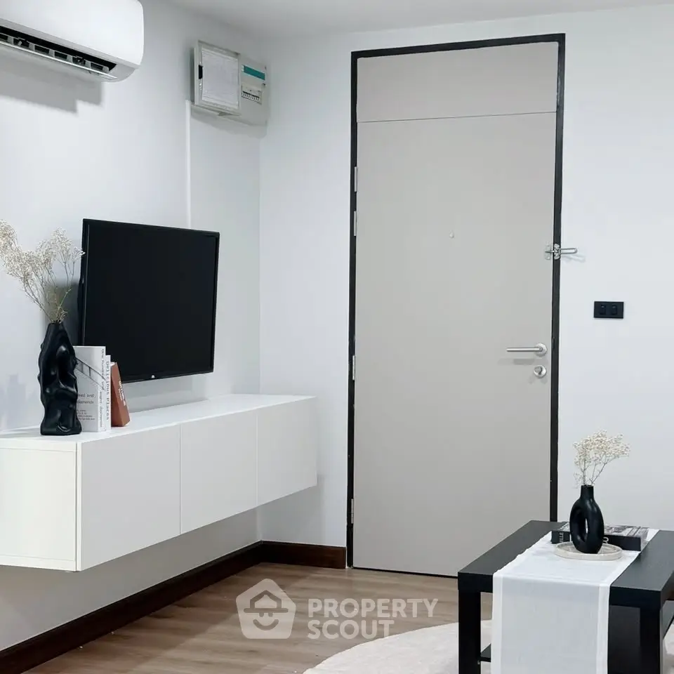 Modern living room with sleek decor and wall-mounted TV