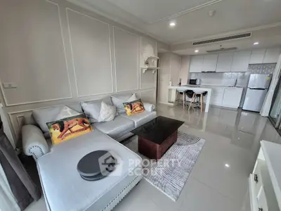 Modern open-plan living room with sleek kitchen and stylish decor